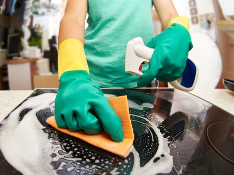 Worker lifting carpet cleaning equipment with correct posture